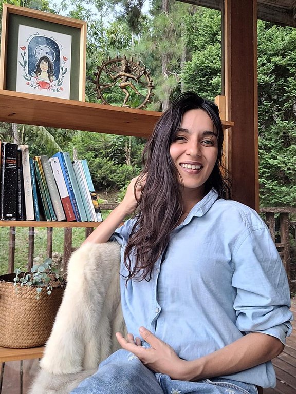 Isabel Caetano no studio de vidro, cercada pela floresta